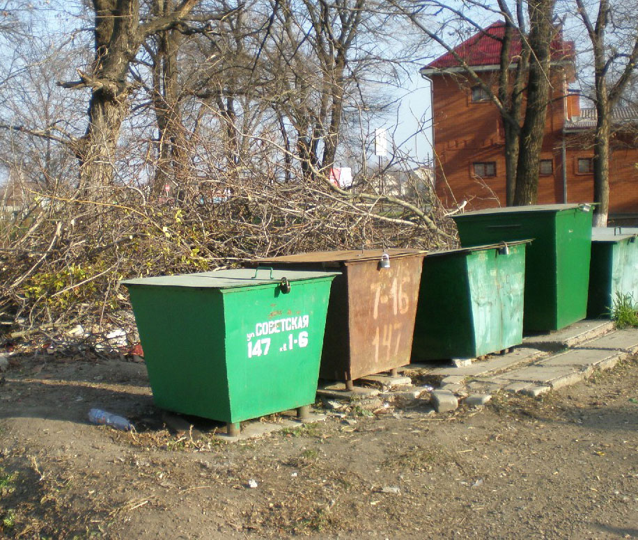 Гора спиленных веток возде мусорных контейнеров и дома возле памятника "Танк",  газета «Единство», Павловский район.